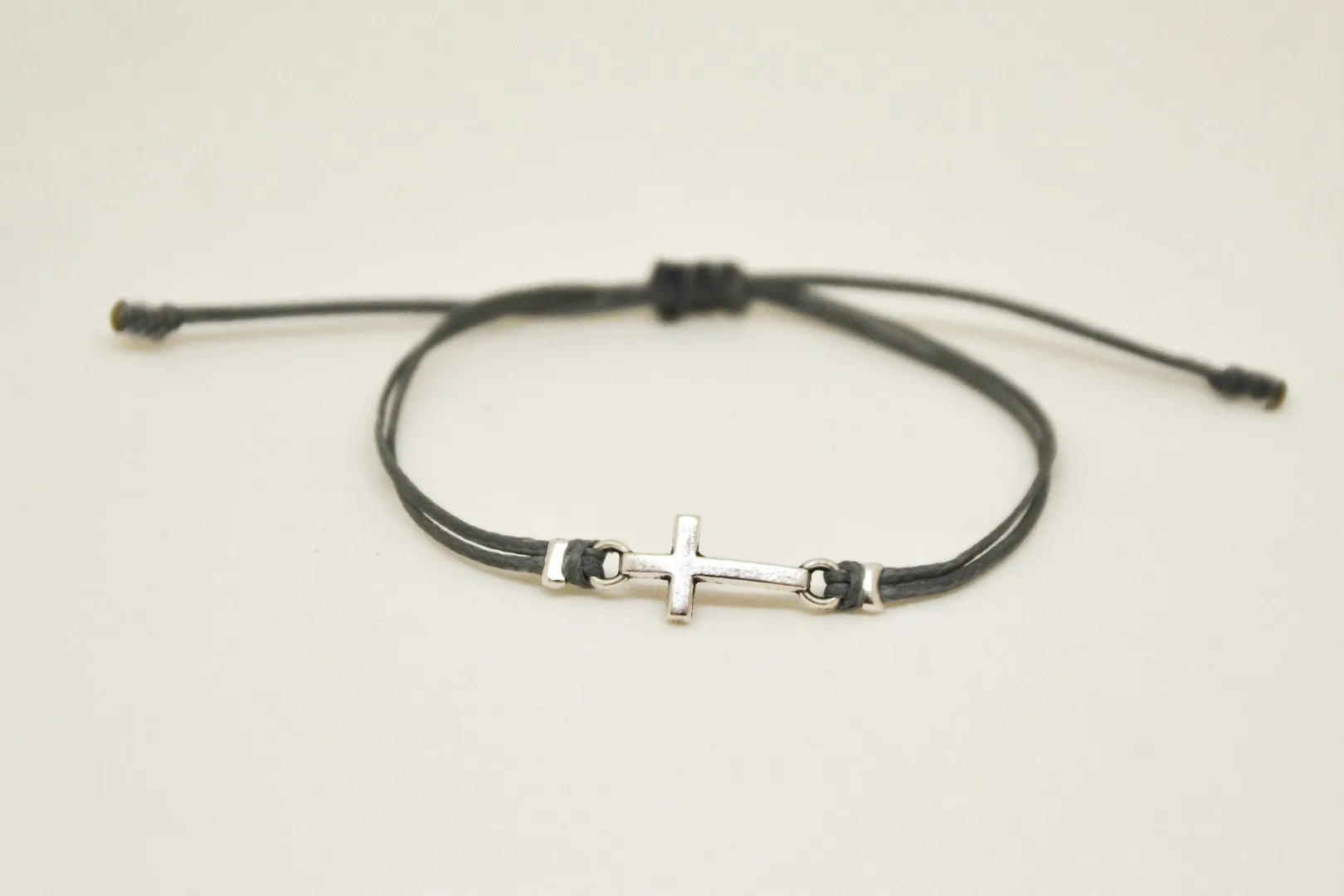 Women bracelet with silver cross charm, Gray cord, adjustable